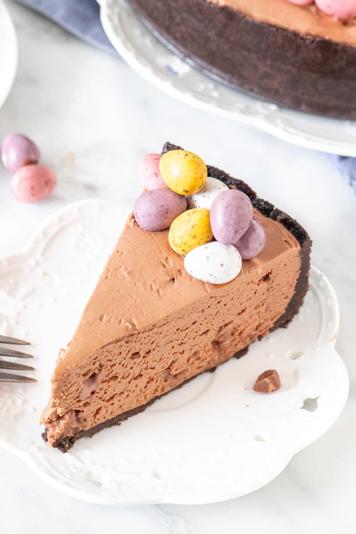 Slice of chocolate cheesecake with mini eggs on top
