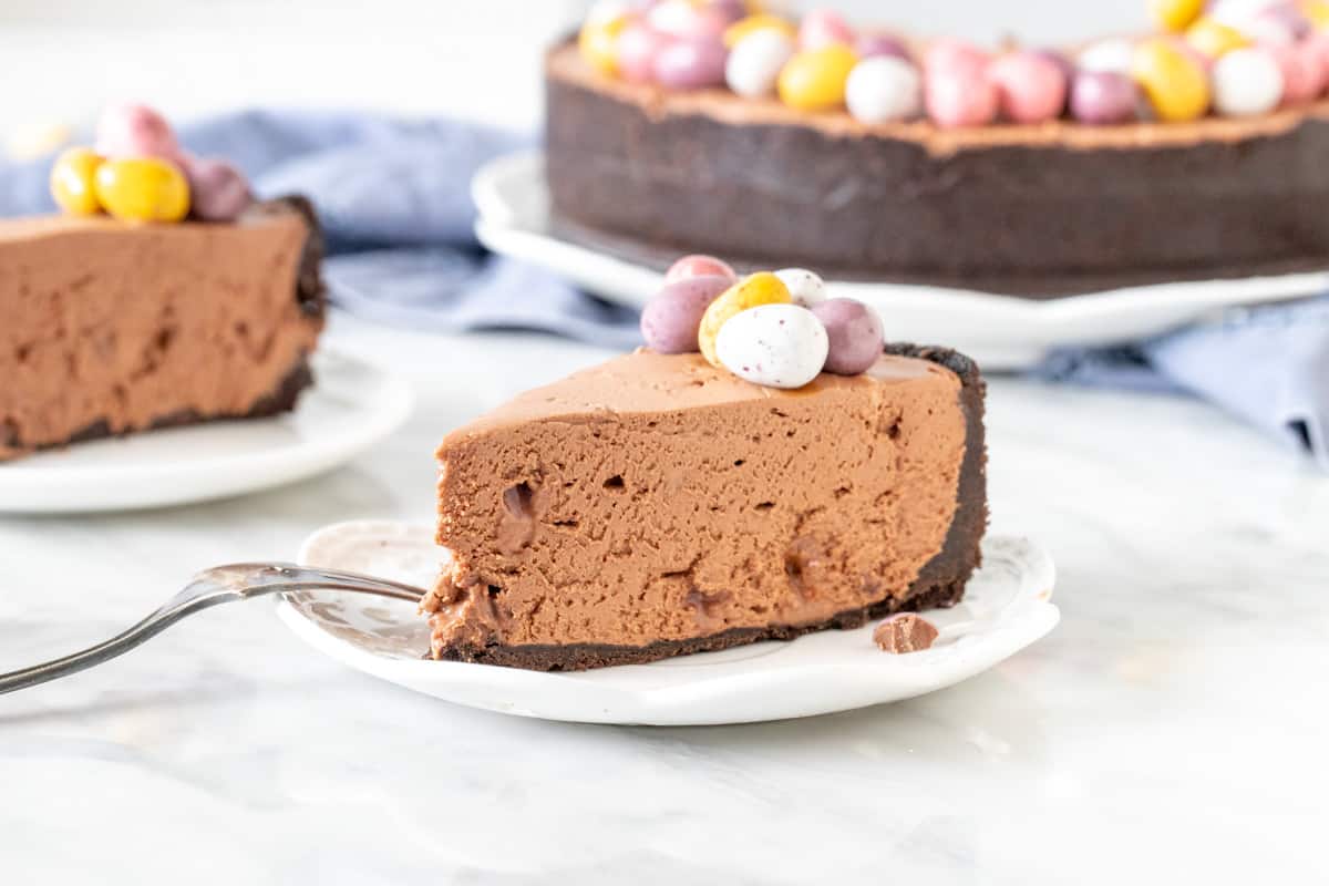 Slice of chocolate cheesecake with Easter chocolates on top