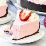 A slice of no-bake strawberry cheesecake with Oreo crust.