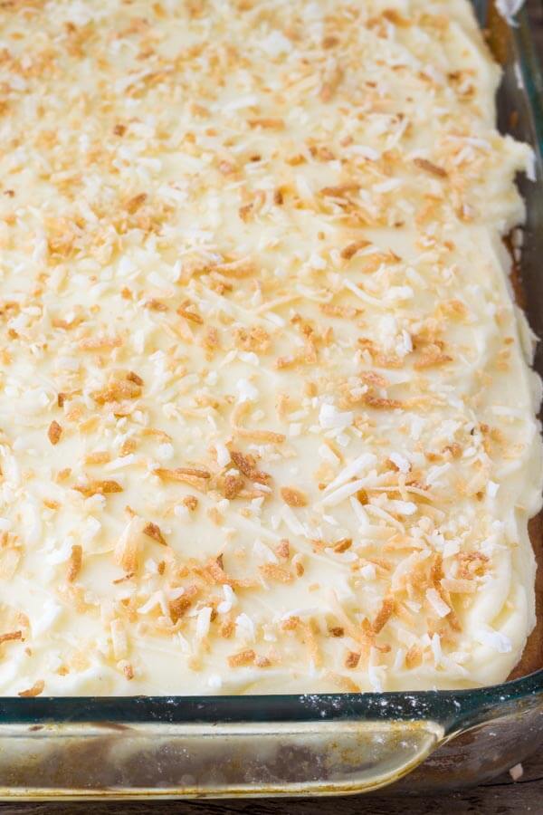 Extra moist coconut cake with coconut buttercream and toasted coconut. Learn all the secrets of how to make coconut cake. 