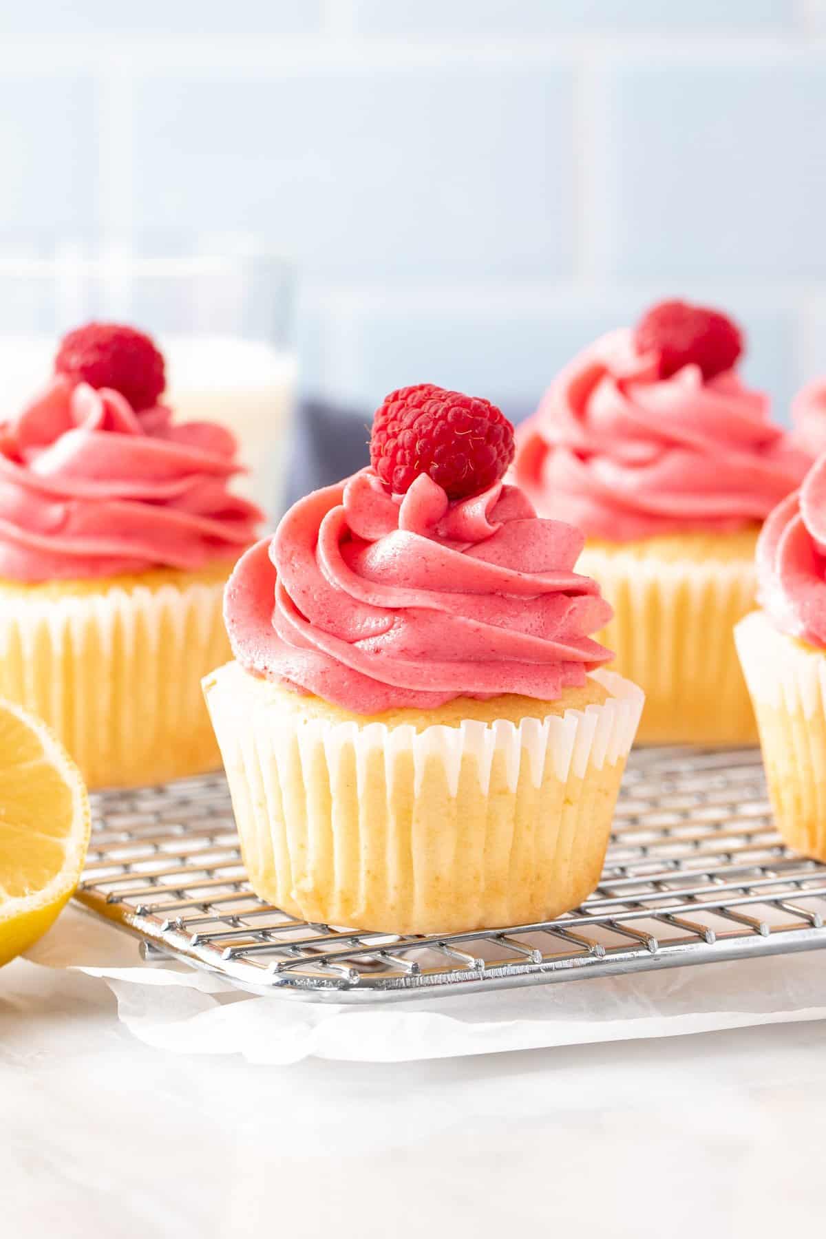 Lemon raspberry cupcakes on a wire cooling rack