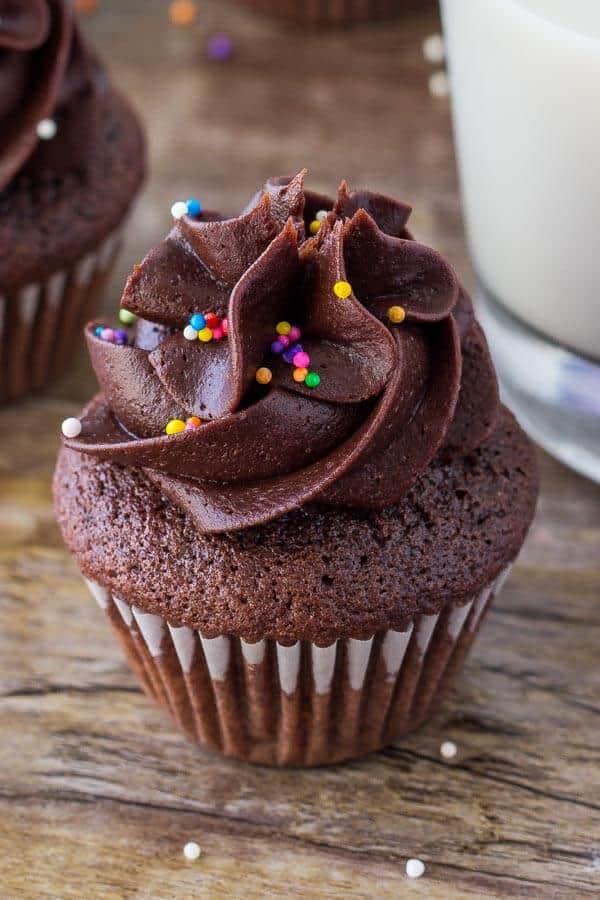 These mini chocolate cupcakes are moist, deliciously fudgy and topped with  a swirl of chocolate frosting. Learn all the secrets to making perfect miniature cupcakes.