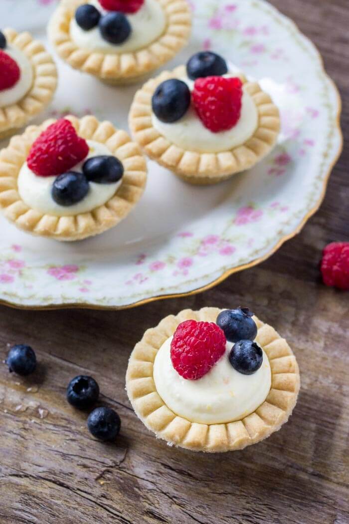 Mini fruit tarts with buttery pastry, creamy vanilla filling, and fresh berries. This recipe is so easy and perfect for entertaining. 