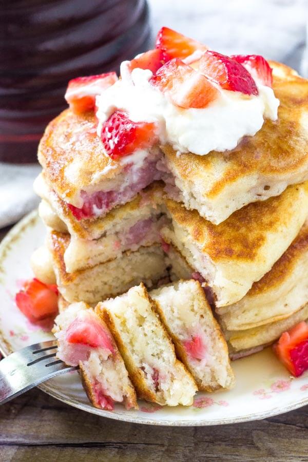 Fluffy strawberry pancakes are perfectly stackable, filled with pieces of strawberries, and perfect for breakfast or dessert. 
