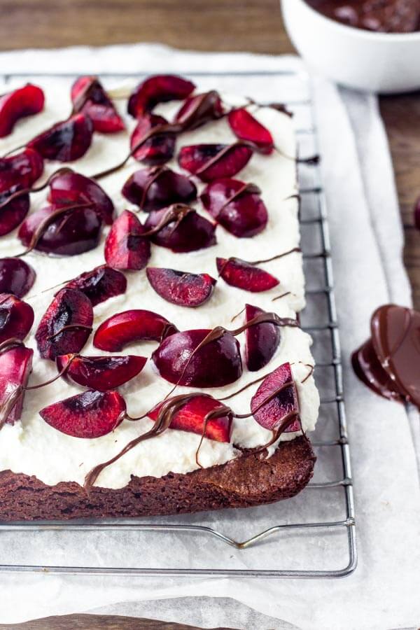 If you love black forest cake - then try these black forest brownies. Extra fudgy brownie topped with sweetened whipped cream & fresh cherries. They're the perfect way to celebrate cherry season. 
