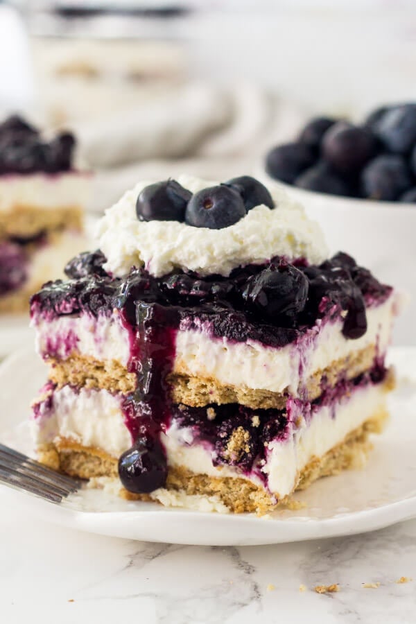 Blueberry Cheesecake Icebox Cake is an easy, no bake, cold & creamy dessert that's perfect for warm weather. It has layers of graham crackers, creamy no bake cheesecake, and juicy berries.