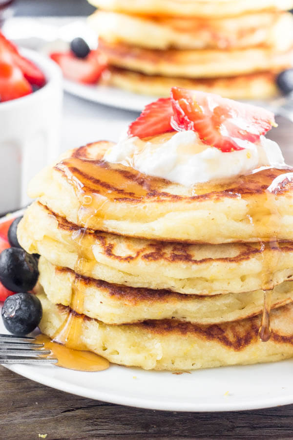 These lemon pancakes have a deliciously bright & sunny flavor thanks to fresh lemon juice and lemon zest. They're extra fluffy with golden edges, and taste delicious with summer berries or syru