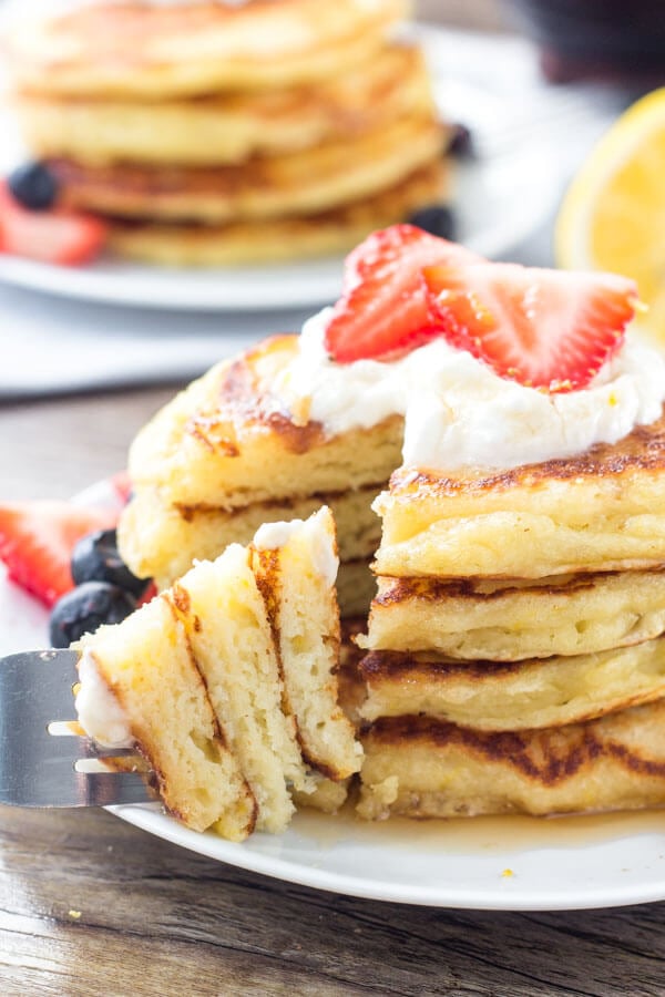 Extra fluffy lemon pancakes have a delicious hint of lemon. Serve with whipped cream, berries & syrup for the perfect breakfast. 