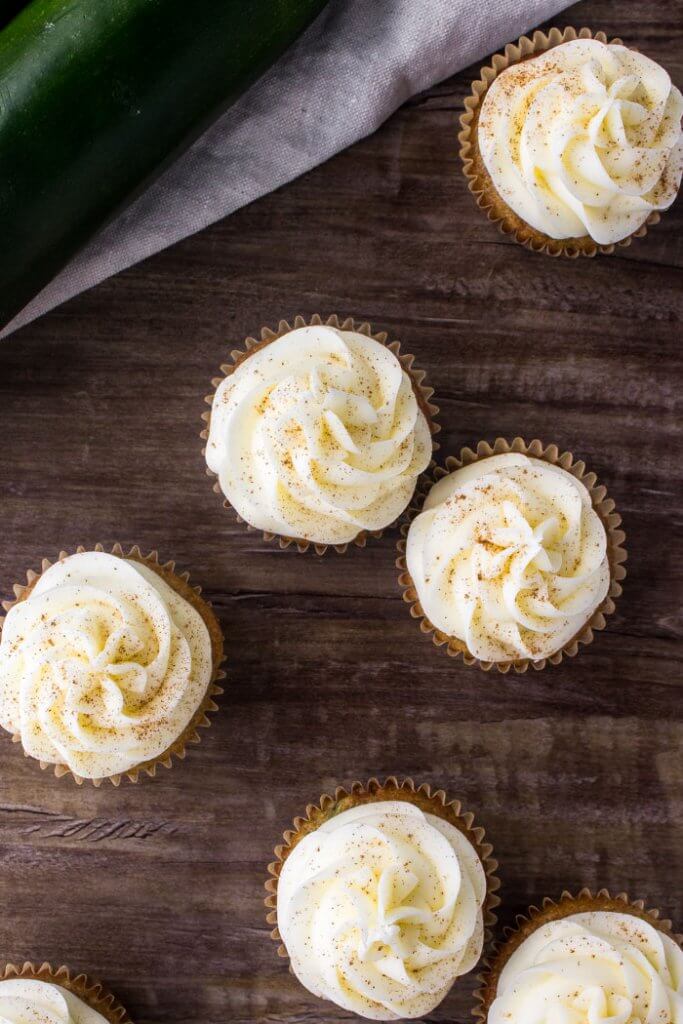 These zucchini cupcakes with cream cheese frosting are extra moist with a delicious spice cake flavor. They're a delicious cupcake recipe for using all the zucchini in season. 