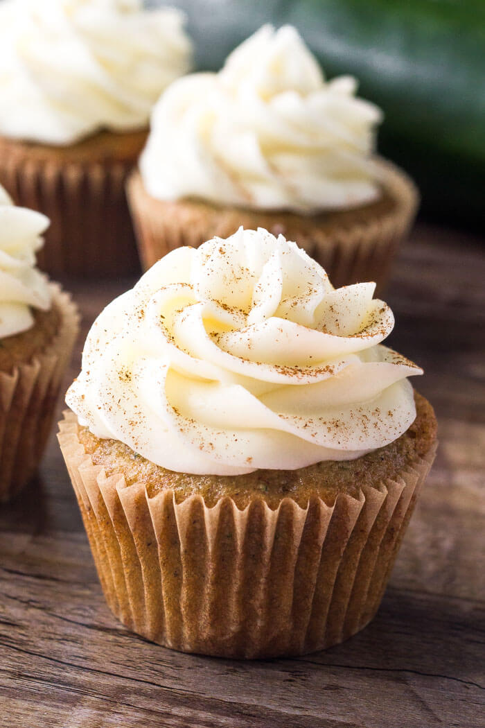 These zucchini cupcakes with cream cheese frosting are extra moist with a delicious spice cake flavor. They're a delicious cupcake recipe for using all the zucchini in season. 