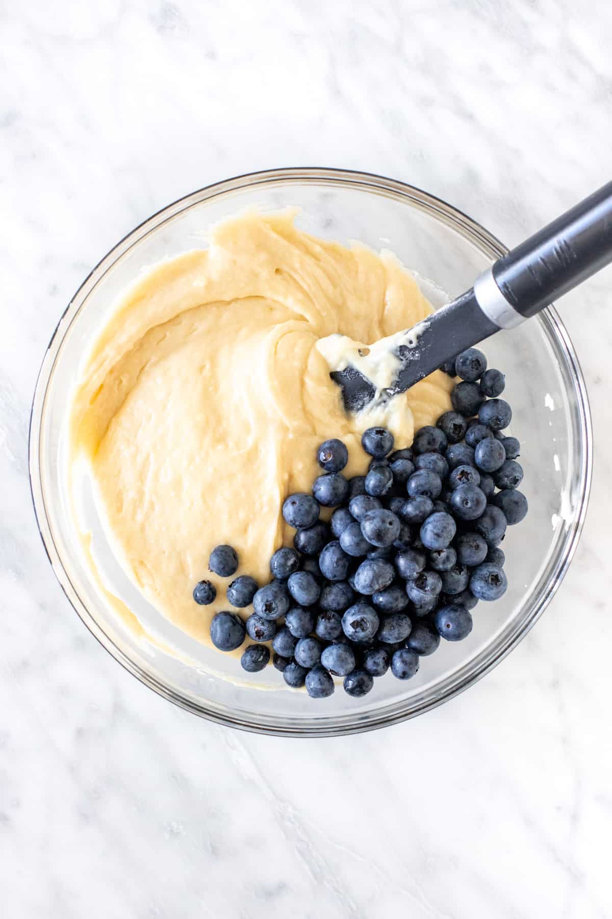 Bowl of muffin batter with blueberries