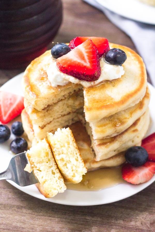 Extra fluffy cream cheese pancakes topped with fresh fruit & whipped cream make for the perfect breakfast. 