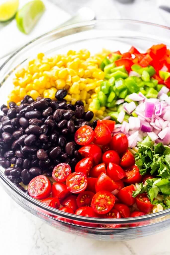 Southwest pasta salad is an easy, delicious recipe for all your summer BBQs and potlucks. It's filled with veggies, corn, black beans & cilantro with a delicious chilli lime vinaigrette dressing.
