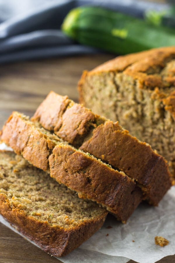 Close up shot of slices of zucchini banana bread to show the delicious golden brown top. 