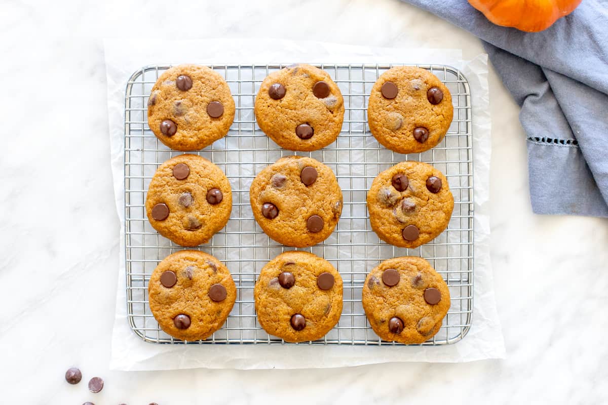 Soft pumpkin cookies on a cooling rack. 