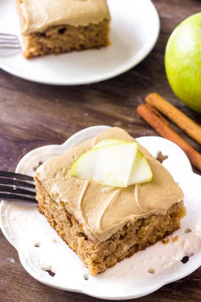 Apple cake with caramel frosting is moist, filled with cinnamon & perfect for fall. 