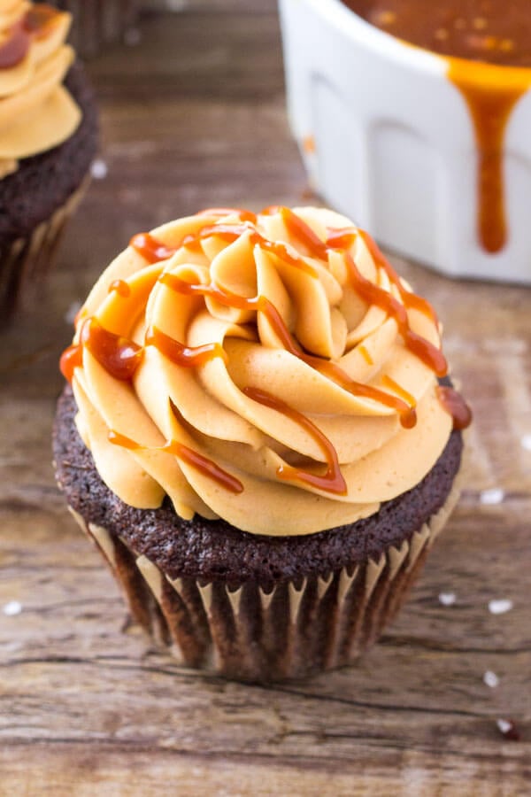 Chocolate cupcakes with caramel frosting are moist, tender and topped with caramel buttercream & a drizzle of salted caramel. 