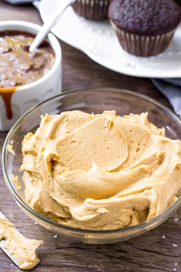 A bowl of salted caramel frosting for decorating chocolate cupcakes. 
