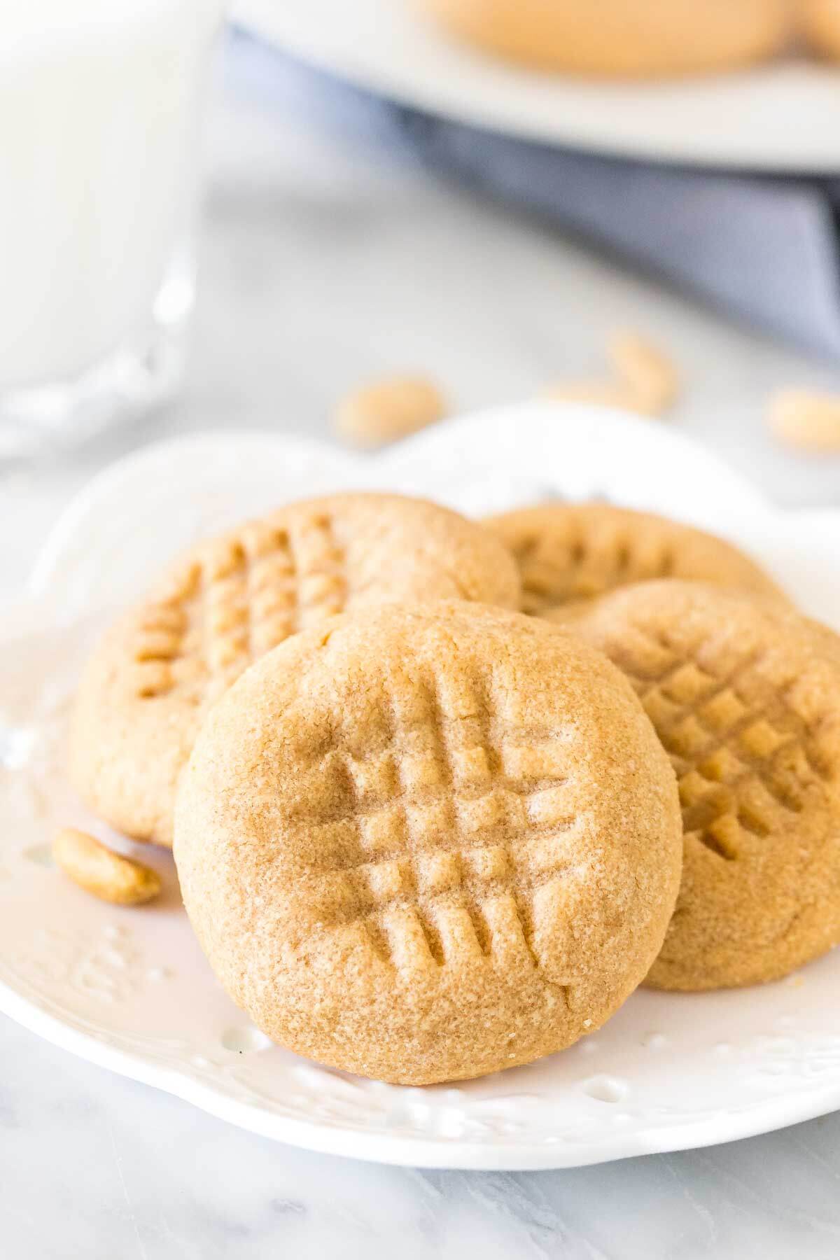 Small plate of 3 ingredient peanut butter cookies with a glass of milk. 
