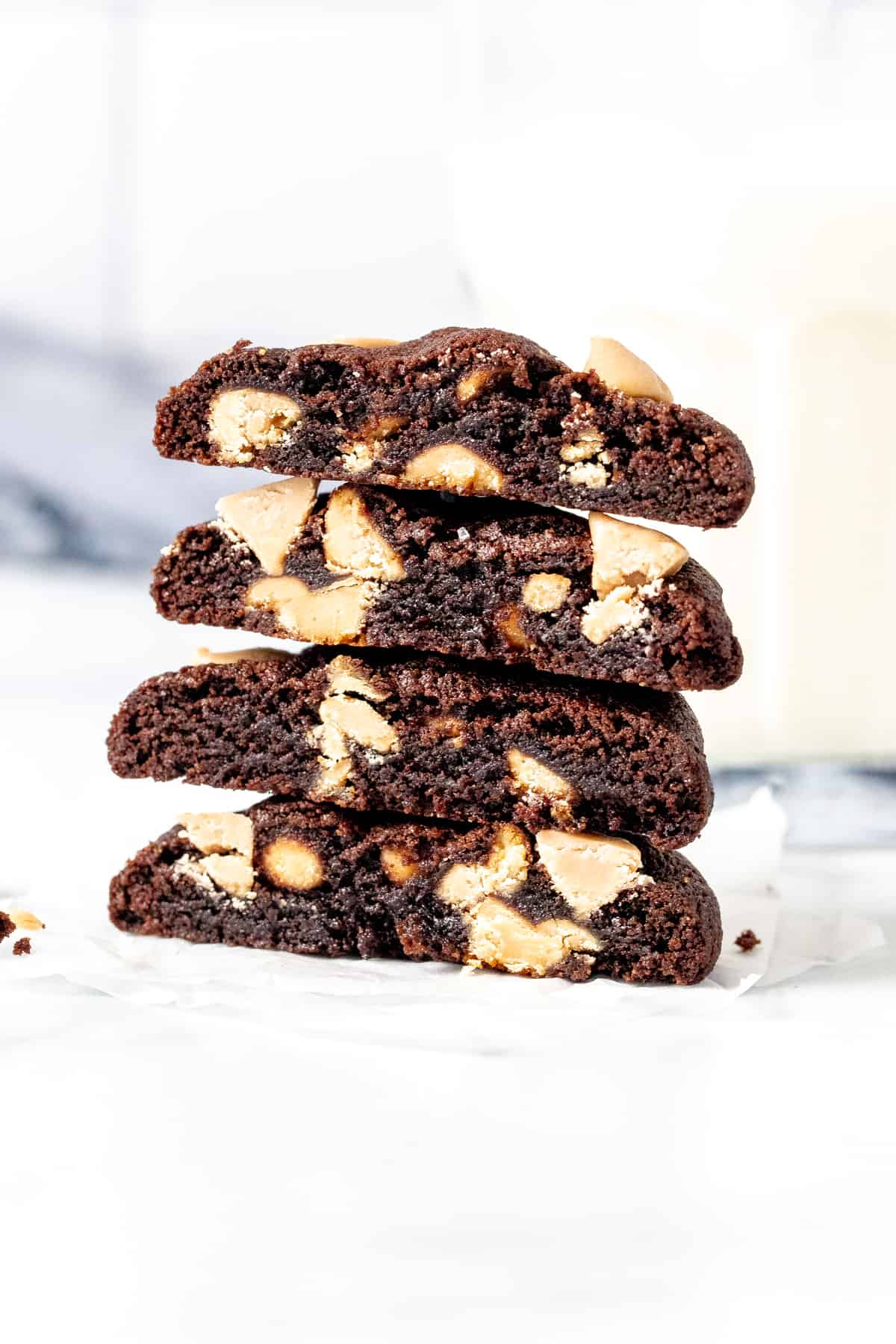 Stack of 4 halves of chocolate cookies with caramel chips