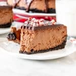 Piece of chocolate candy cane cheesecake with glass of milk