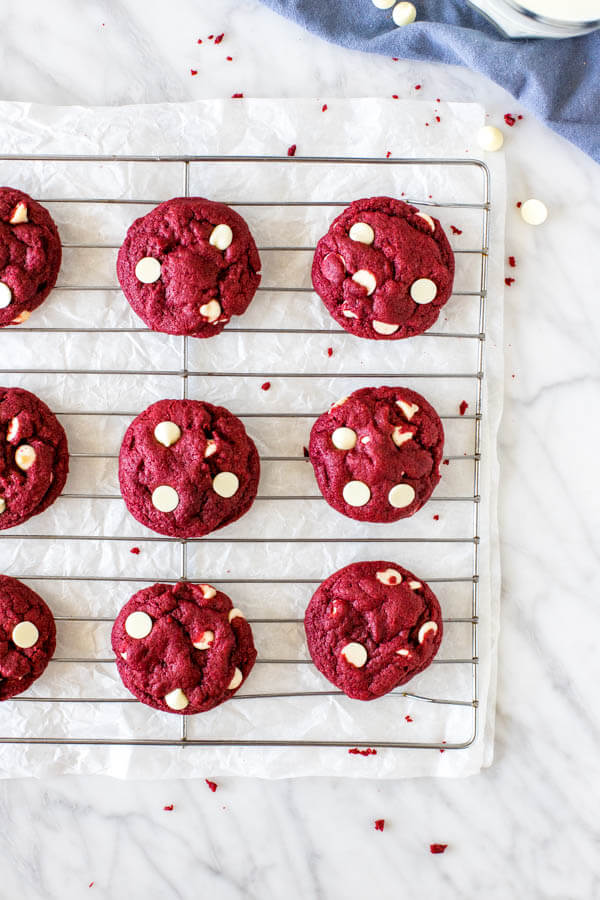 Cooling rack of red velvet white chocolate chip cookies