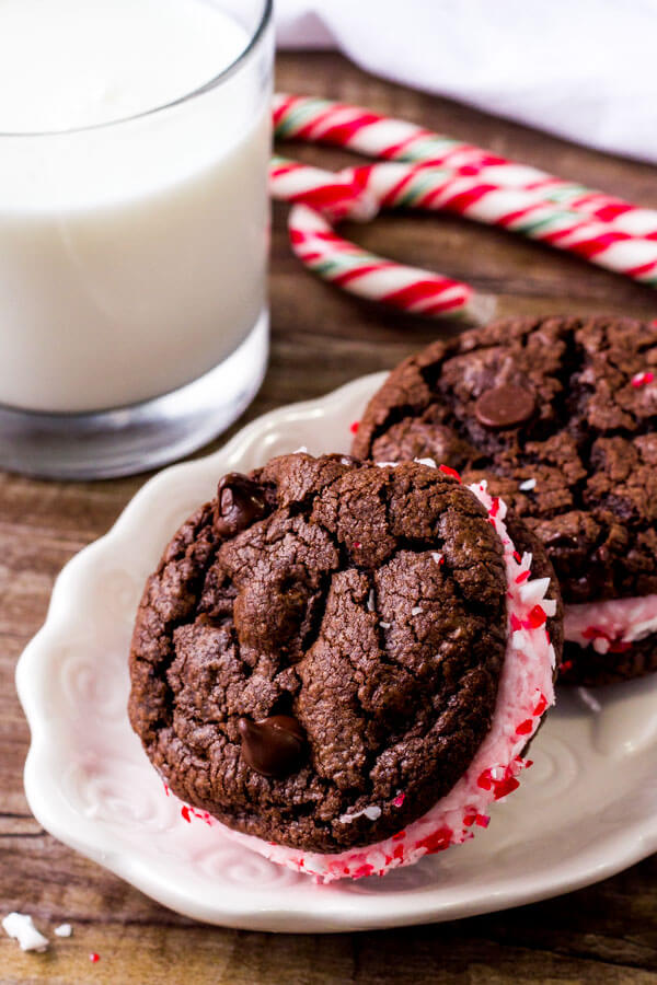 Chocolate candy cane sandwich cookies have fluffy candy cane frosting and fudgy cookies. 