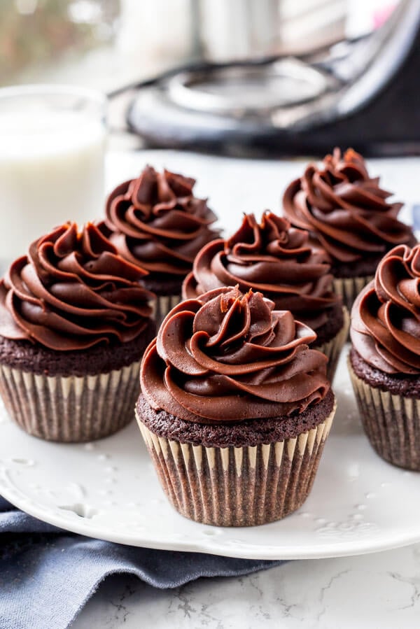 A plate of cupcakes with cream cheese chocolate frosting 