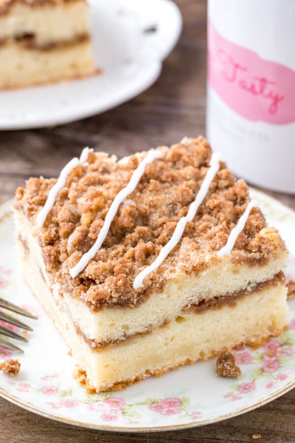 A slice of cinnamon coffee cake with cinnamon filling and brown sugar streusel topping. 