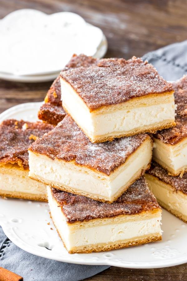  Sopapilla cheesecake bars have a thick layer of creamy cheesecake between 2 sheets of flaky pastry. Then they're topped with buttery cinnamon sugar.