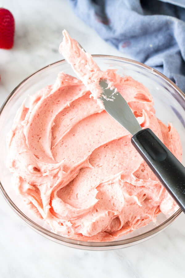 Bowl of strawberry buttercream frosting. 