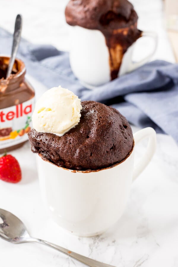 A fudgy, gooey Nutella Mug Cake with chocolate ice cream on top makes for the perfect single serving dessert. 
