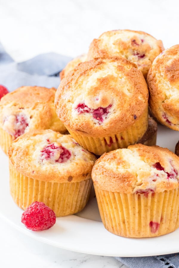 A plate of moist raspberry muffins with a hint of lemon in the batter. 