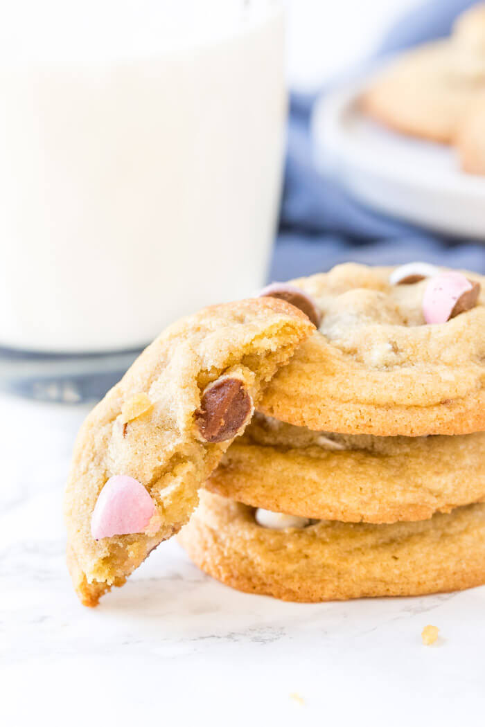 A stack of 3 soft and chewy mini egg cookies with one cookie lying on its side. 