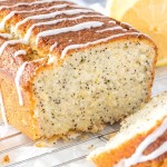 Lemon poppy seed bread on a cooling rack with a few slices cut to show the moist, tender texture of the bread.