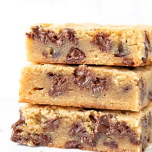 Stack of three chewy blondies with chocolate chips