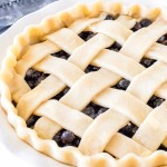 Homemade pie with a lattice crust and fluted edges.