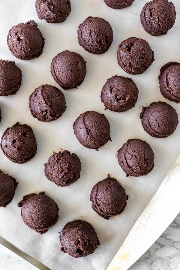 Tray of double chocolate chip cookie dough formed into balls. 