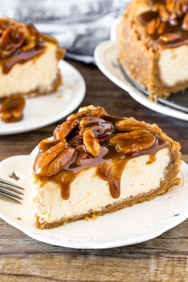 Slice of pecan pie cheesecake with gooey topping.