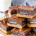 A plate of slutty brownies with a chewy peanut butter cookie bottom.