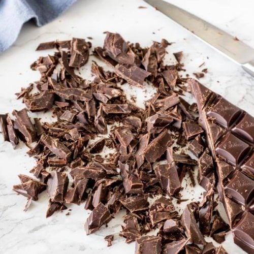 A bar of chocolate cut up before melting.