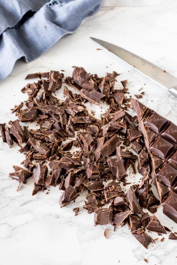 A bar of chocolate cut up before melting. 