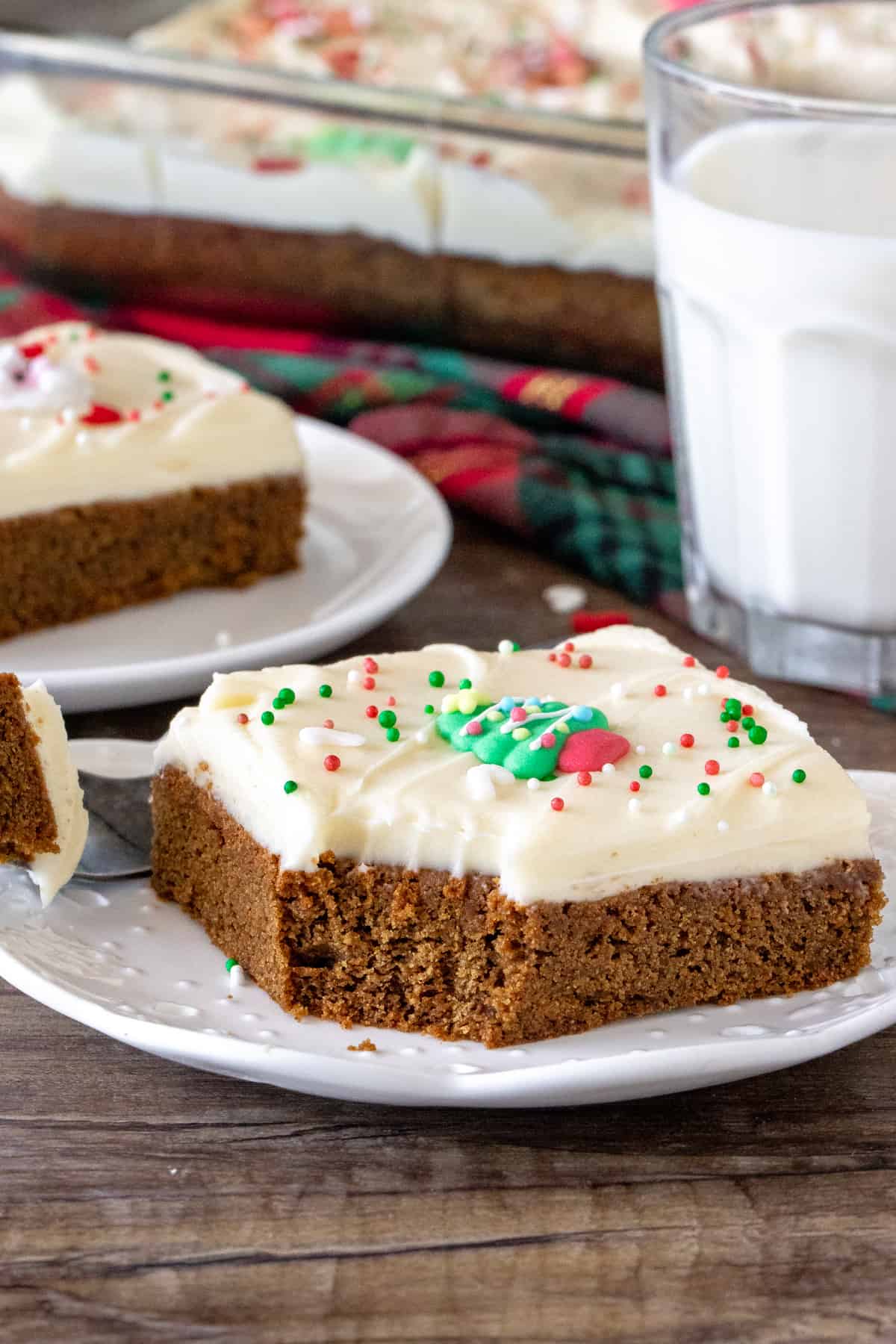 Gingerbread cookie bar on a plate with a bite taken out.