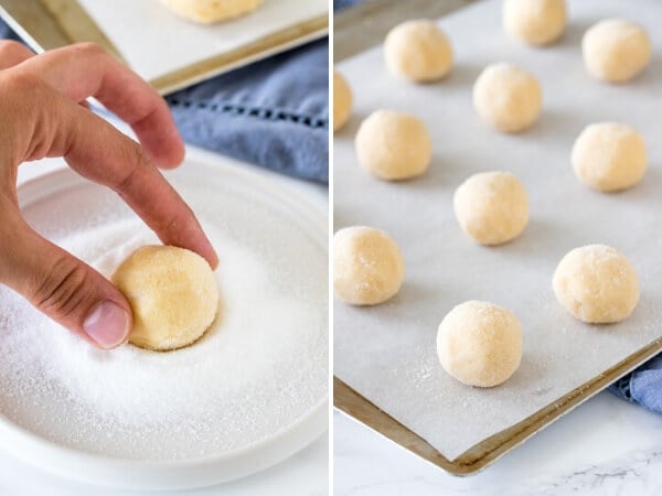 Rolling a drop sugar cookie dough ball in sugar, and a tray of sugar cookie balls on a lined cookie sheet.