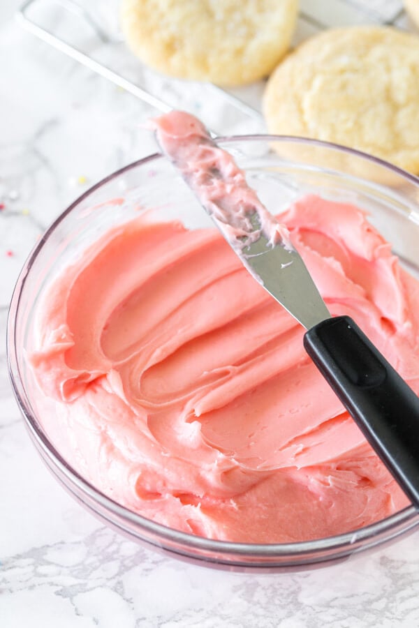 A bowl of pink sugar cookie frosting