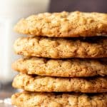 Stack of chewy oatmeal cookies with glass of milk