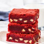 A stack of 3 red velvet white chocolate chip brownies.