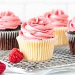 Vanilla and chocolate cupcakes decorated with raspberry frosting made from fresh berries