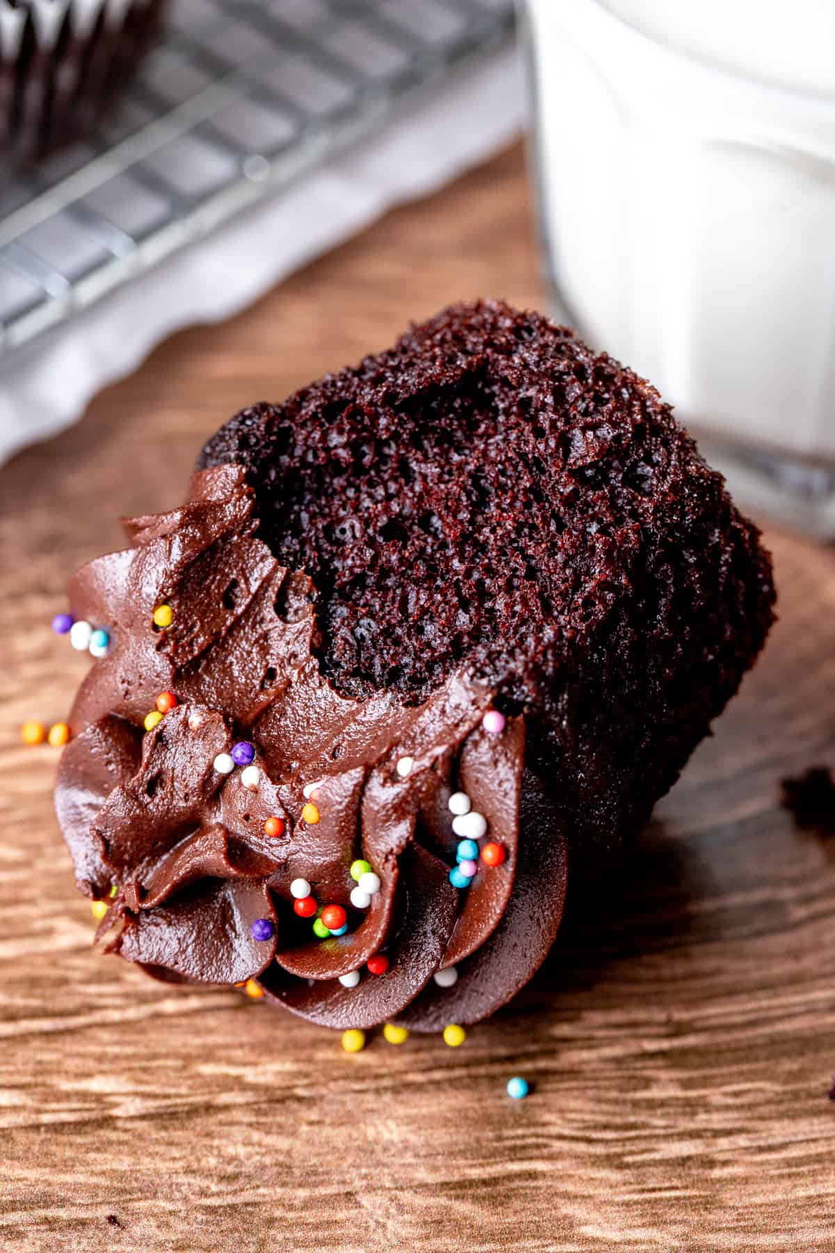 Double chocolate cupcake with bite taken out, on its side
