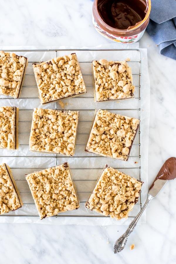 9 slices of shortbread bars with crumb topping on a cooling rack. 